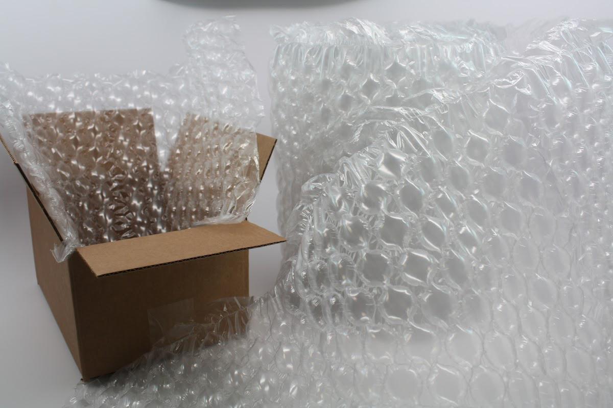 Bubble wrap and reusable packaging in an open cardboard box